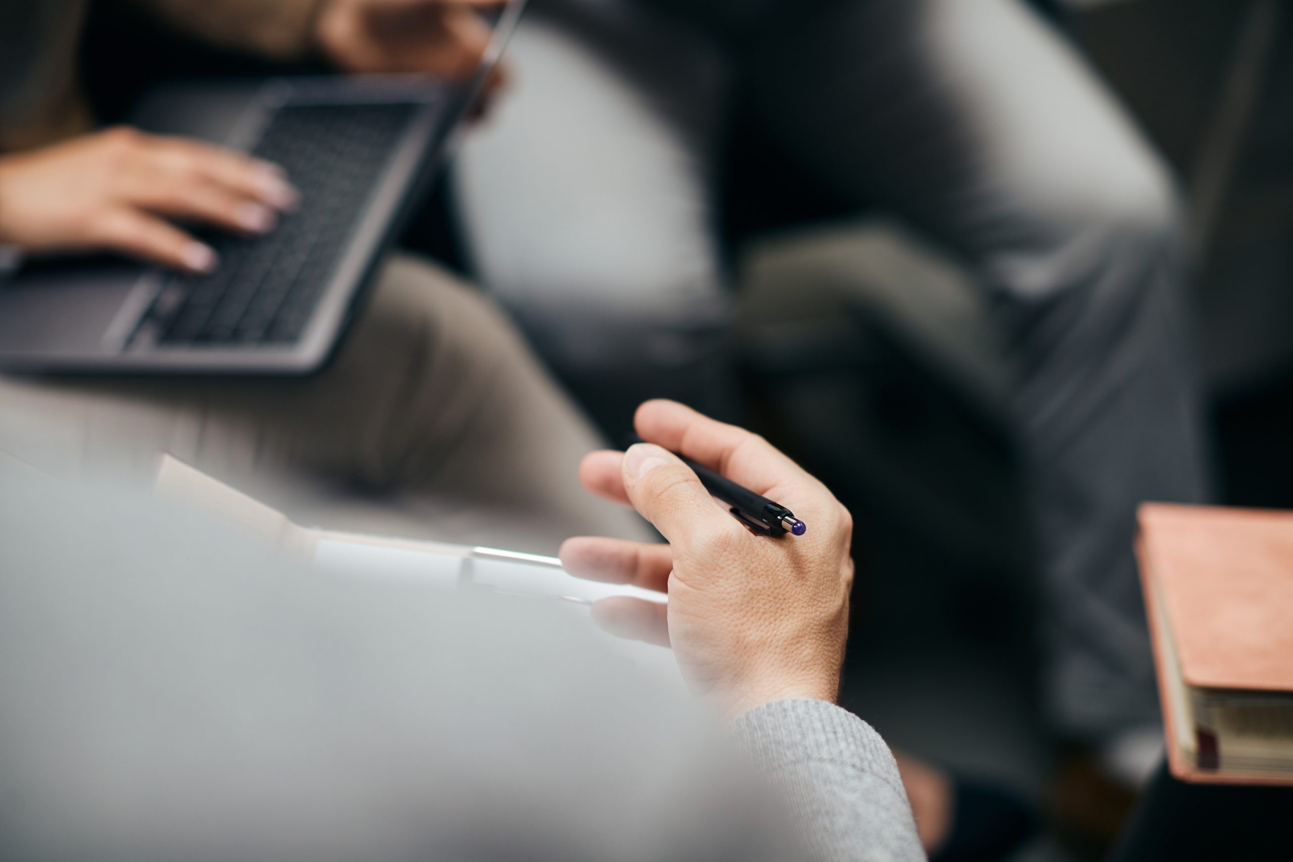 Close-up of entrepreneur having business meeting with colleagues in the office.