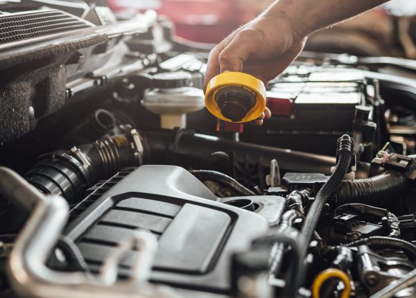 A closeup shot of auto mechanic hands doing car technical inspection in service